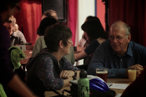 Audience and panel in animated discussion