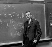 Paul Dirac, the inventor of quantum mechanics, in front of a blackboard of equations